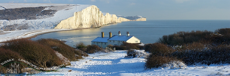 slides/Coast Guards in Snow.jpg coast guard cottages east sussex coastal coast blue sky winter sunny seaside snow cold bitter panoramic cliffs white lighthouse seven sisters country park cuckmere haven river beach Coast Guards in Snow